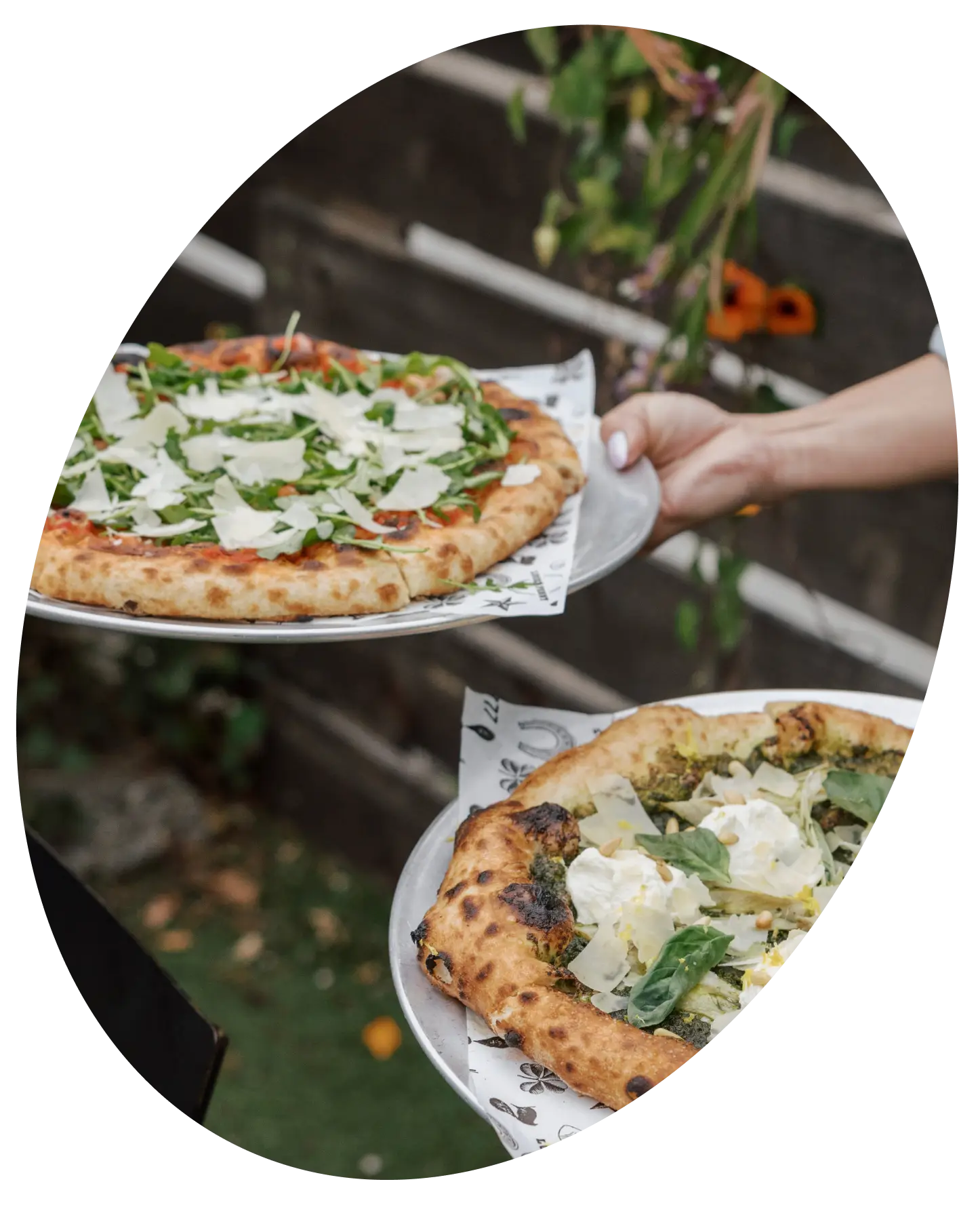 Person serving two pizzas